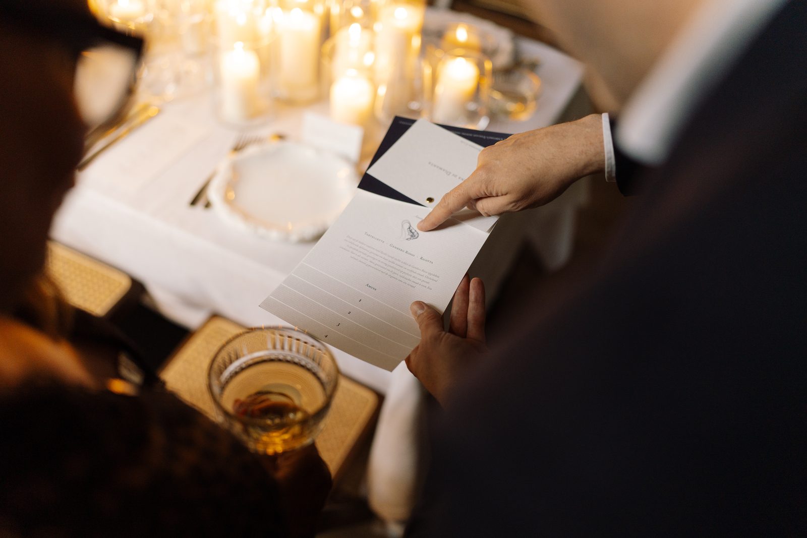 Sparkling wine being poured into vintage cut-crystal coupe glasses during the reception