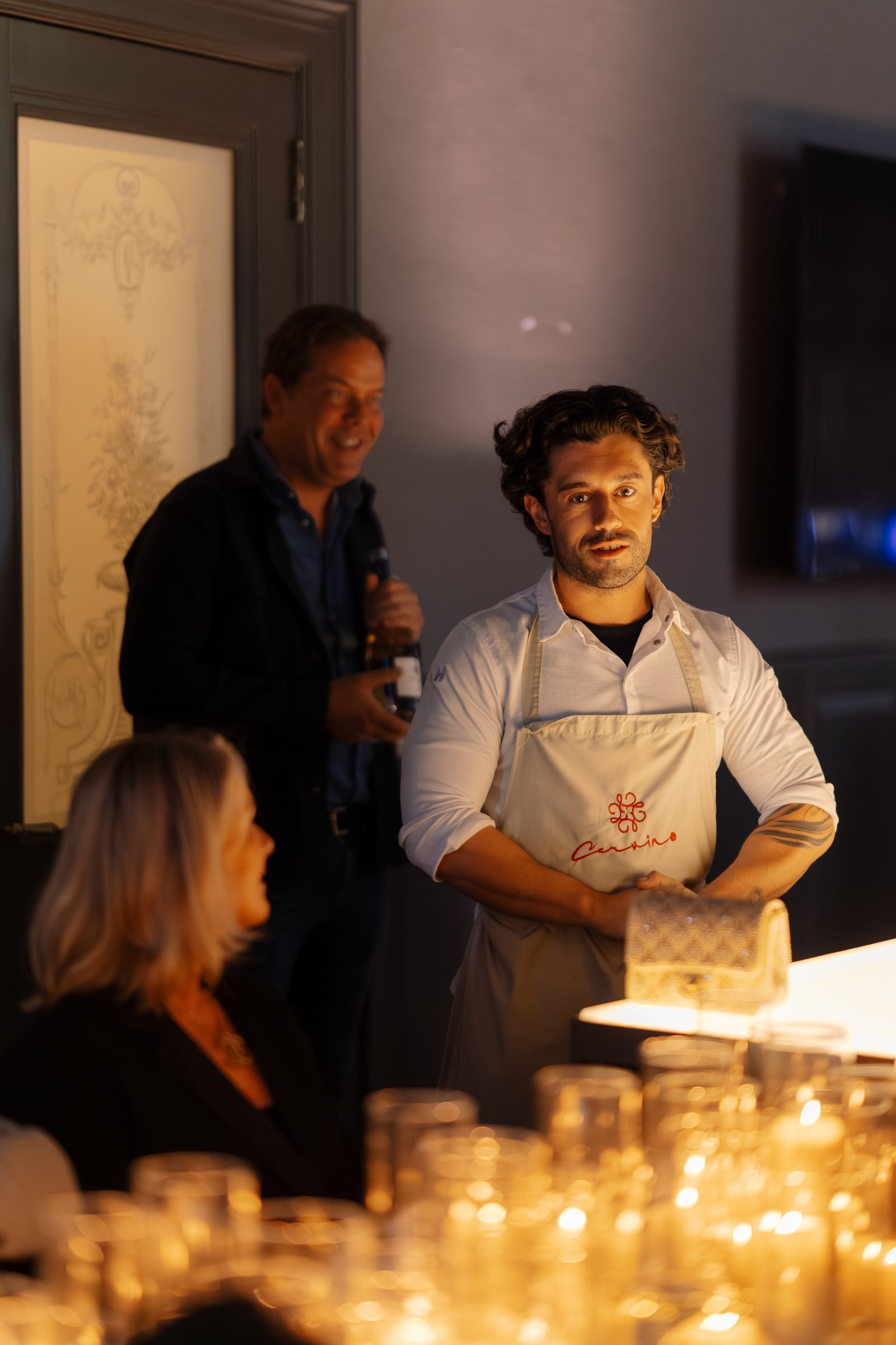 Michael Cervino among the guests, speaking warmly beside the candlelit table