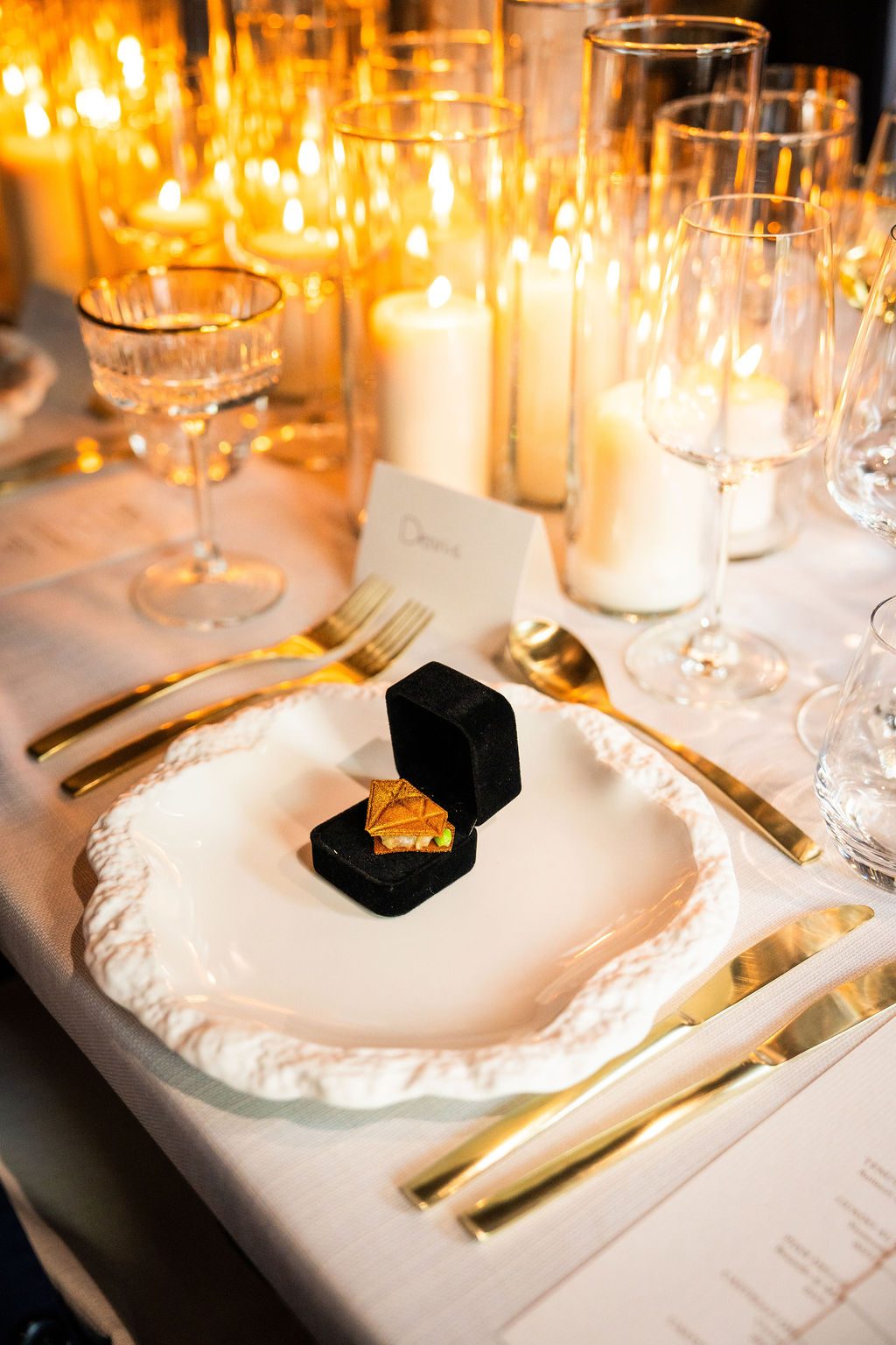 A savoury starter ring topped with fresh microgreens over a dark balsamic reduction on a decorative white plate