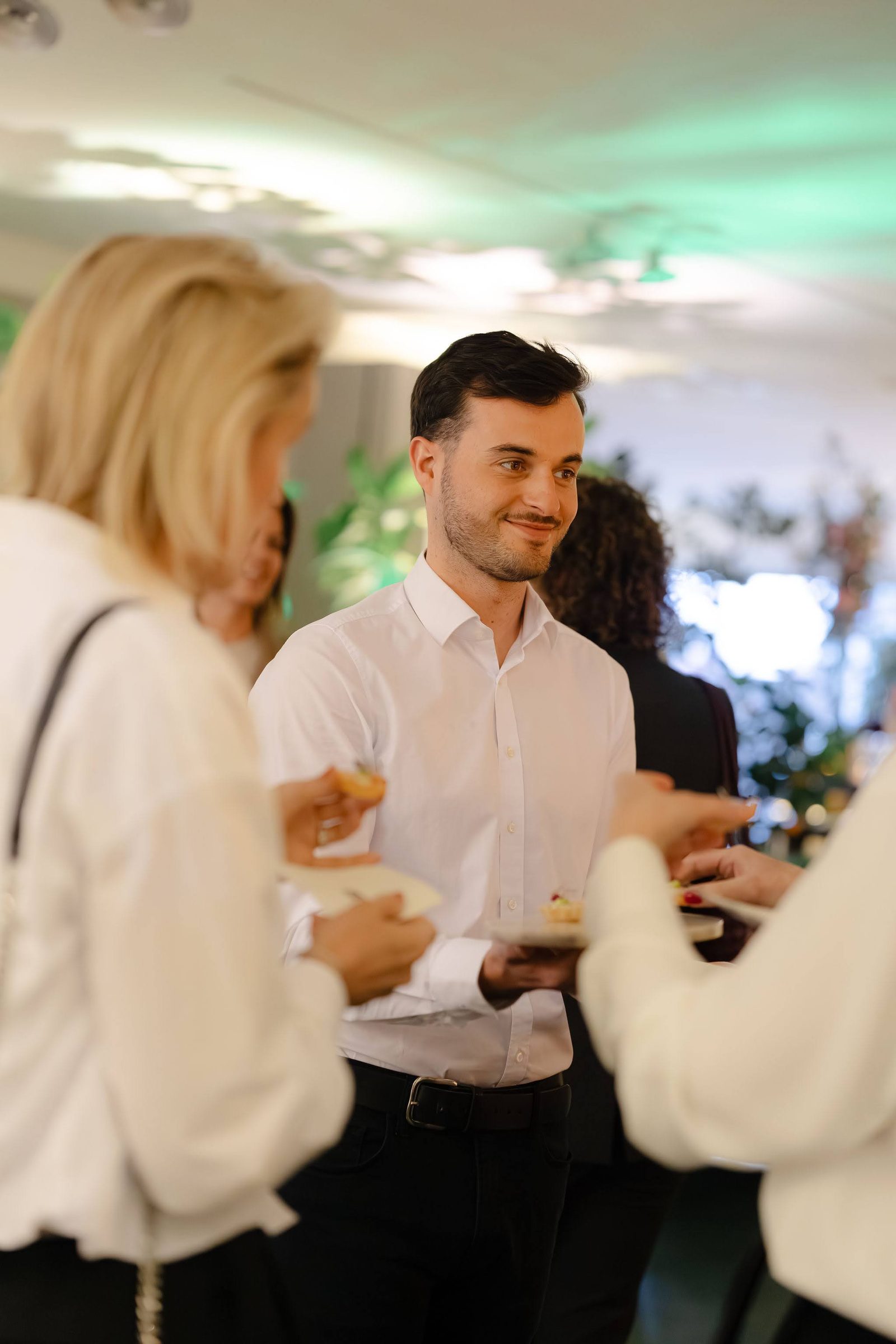 Guests seated along the floral-draped table during tableside service