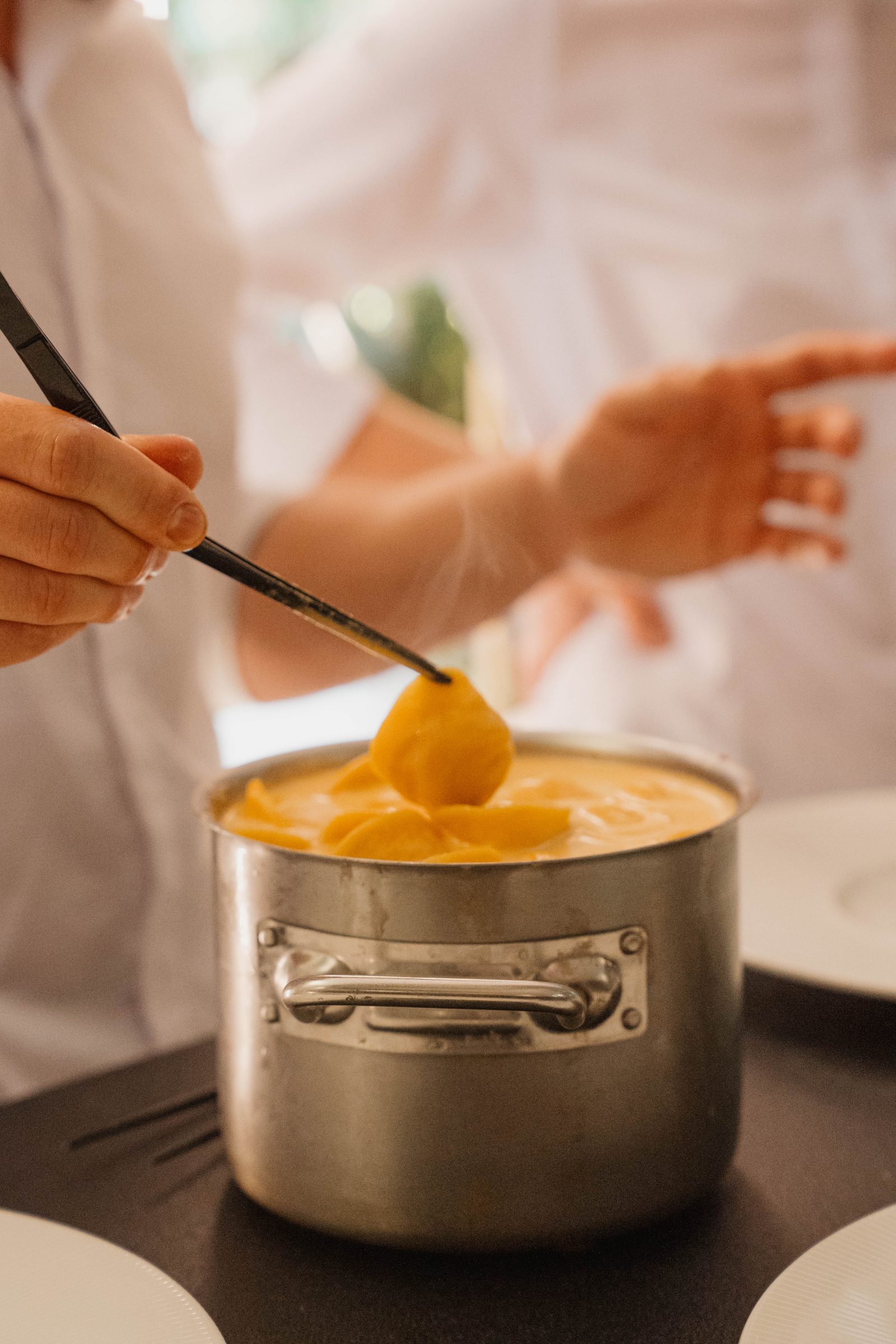 Chefs meticulously plating appetizers along the kitchen pass
